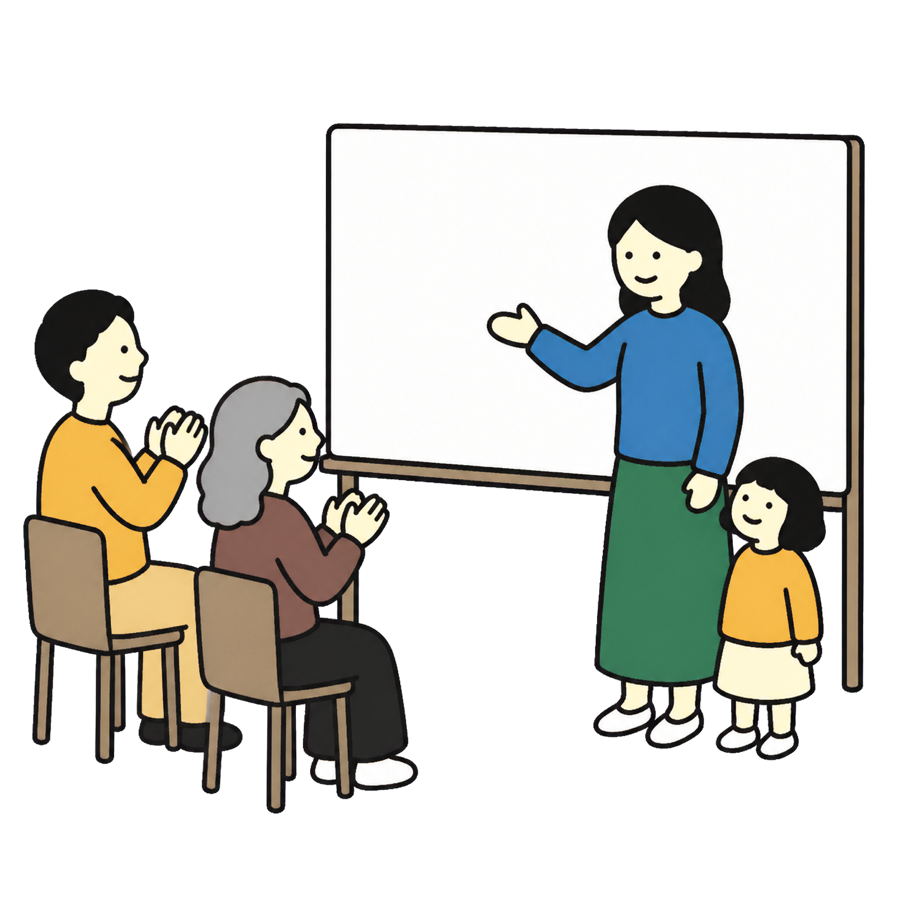 母親がホワイトボードの前で話し、大人たちが拍手し、子どもが見上げている